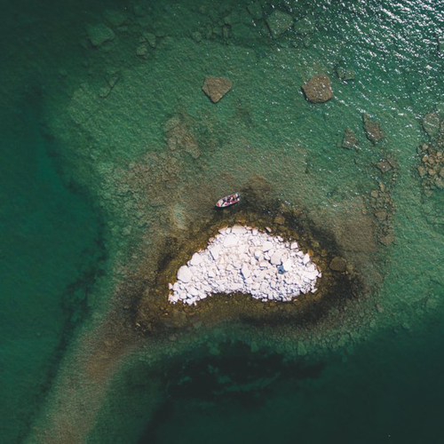 Clear blue green waters at snake island from above