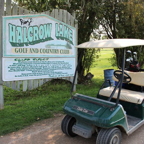 Halcrow Lake Golf & Country Club sign & golf cart.